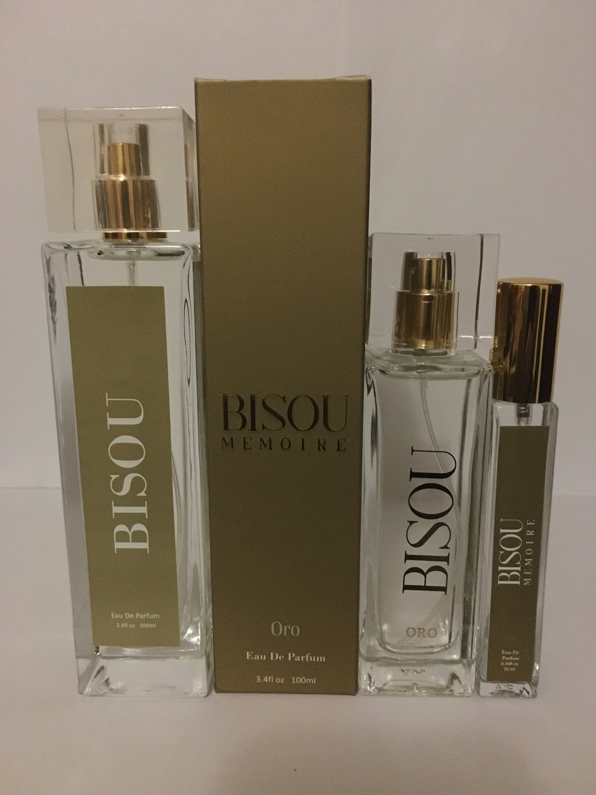 A group of three bottles of perfume on top of each other.